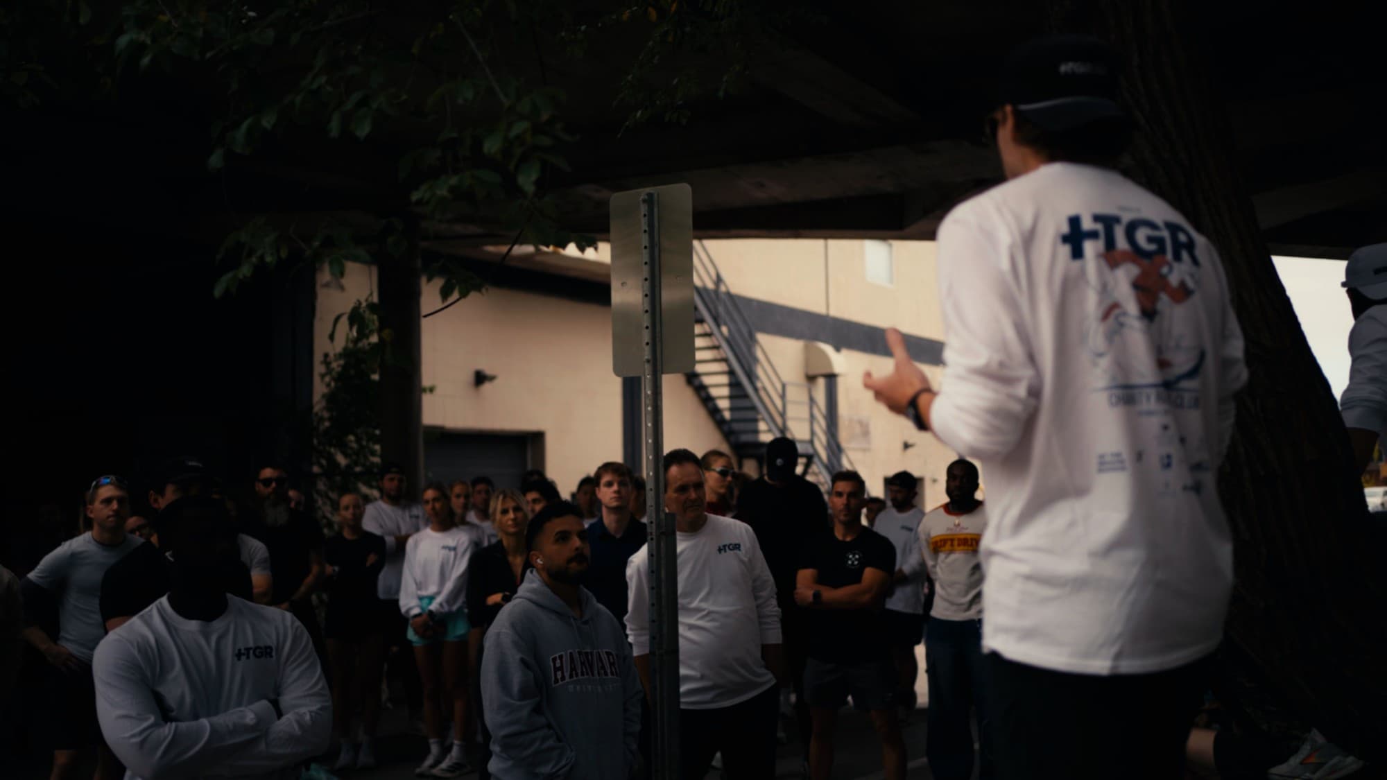 HTGR community event — speaker addressing a large crowd of supporters wearing HTGR shirts